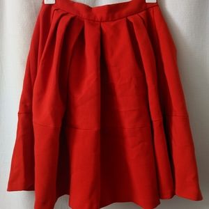 Bright red pleated skirt